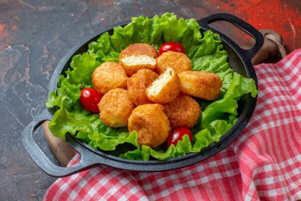 bottom-view-chicken-nuggets-lettuce-cherry-tomatoes-pan-dark-red-background